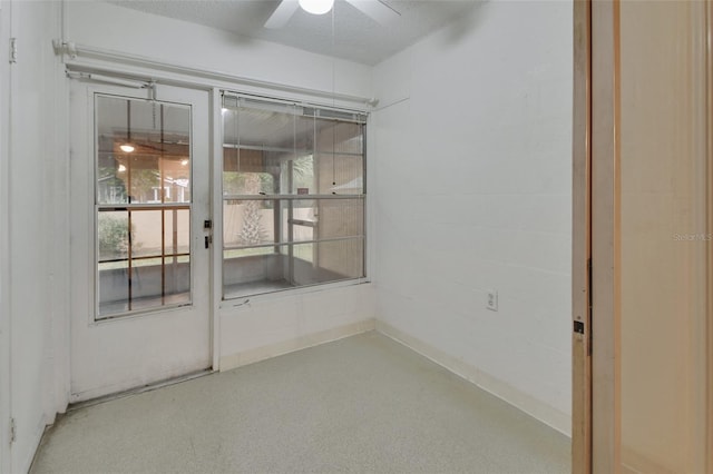 empty room featuring ceiling fan and a textured ceiling