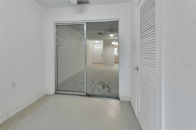 interior space featuring ceiling fan and a textured ceiling