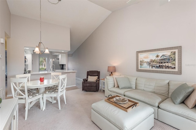 living room with sink, light colored carpet, and high vaulted ceiling