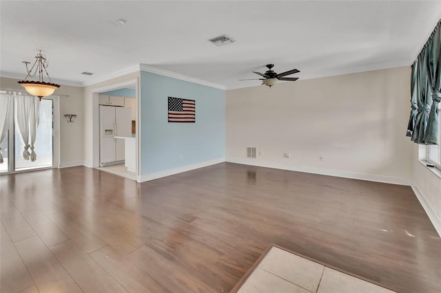 unfurnished living room featuring hardwood / wood-style flooring, crown molding, and ceiling fan