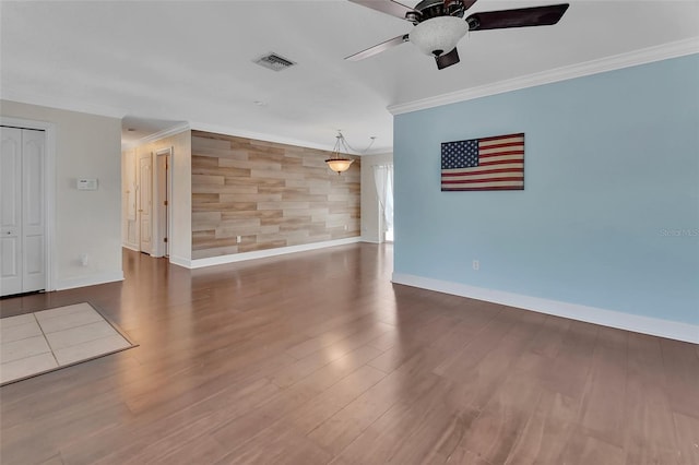 spare room with dark hardwood / wood-style flooring, ornamental molding, and ceiling fan