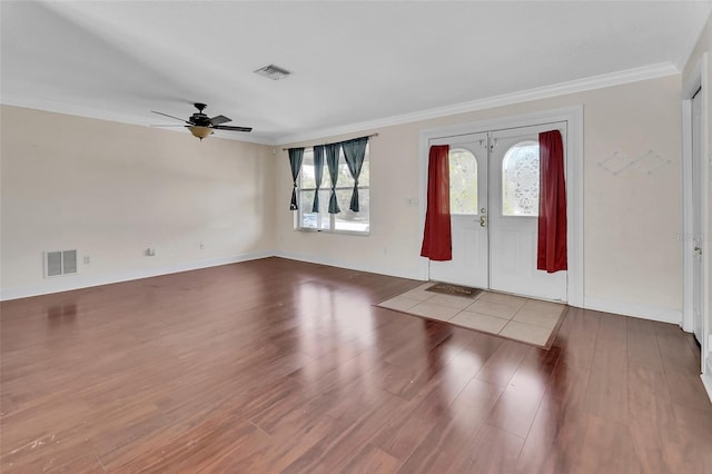 entrance foyer featuring ornamental molding, hardwood / wood-style floors, and french doors