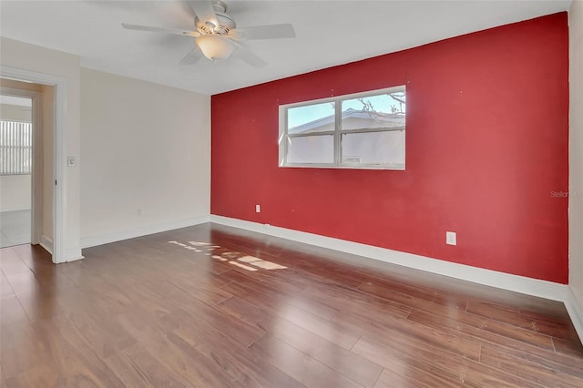 spare room featuring hardwood / wood-style floors and ceiling fan