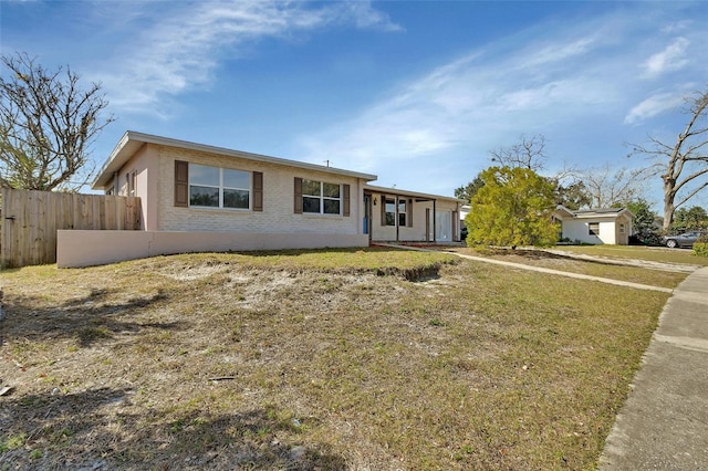 ranch-style home with a front lawn