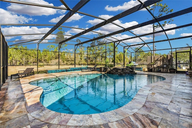 view of swimming pool with a lanai and a patio area