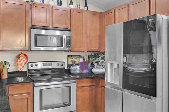 kitchen with dark stone countertops and appliances with stainless steel finishes