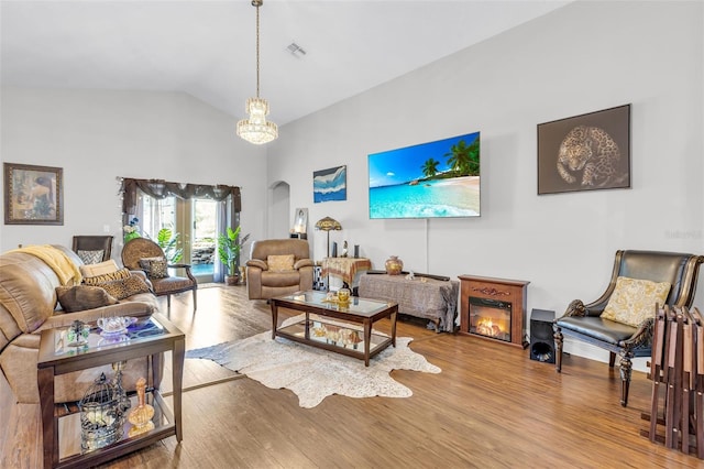 living room featuring hardwood / wood-style flooring and lofted ceiling