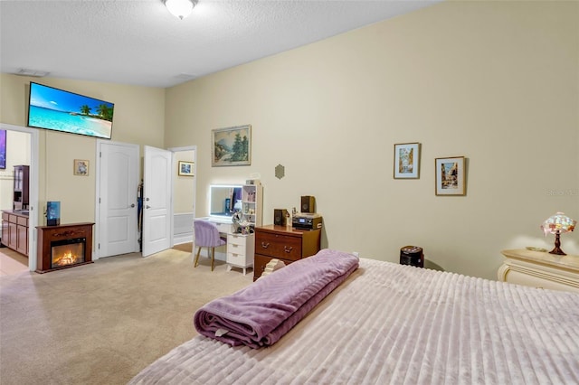 carpeted bedroom with vaulted ceiling and a textured ceiling