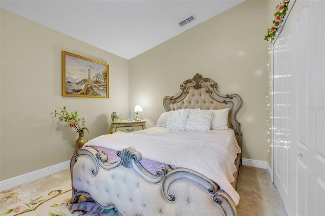 bedroom with lofted ceiling and light carpet