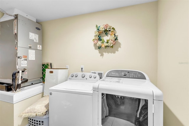 laundry room with separate washer and dryer and heating unit