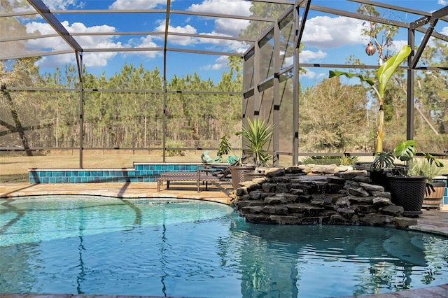 view of swimming pool with a patio and a lanai