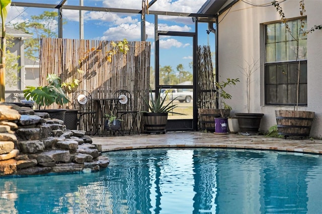 view of pool featuring a lanai and a patio