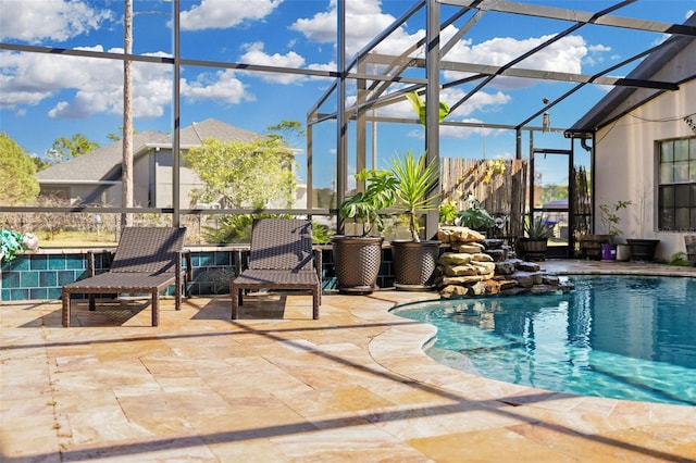 view of swimming pool with a patio area and glass enclosure