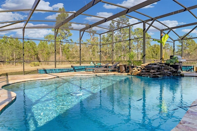 view of pool featuring glass enclosure