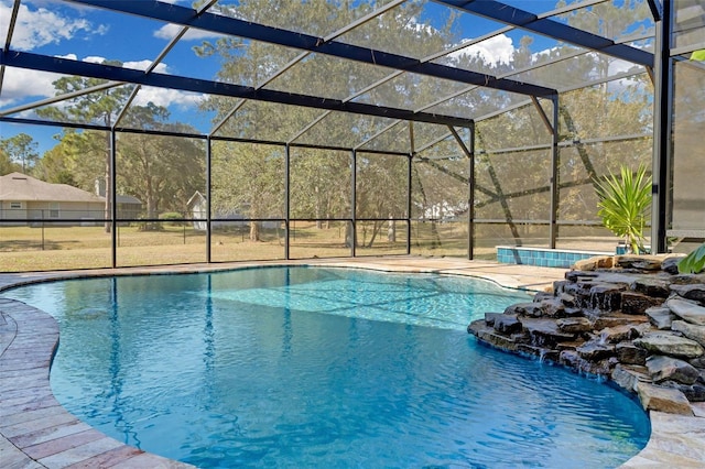 view of pool featuring pool water feature and glass enclosure