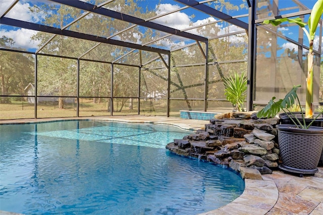 view of swimming pool featuring a patio, pool water feature, and glass enclosure