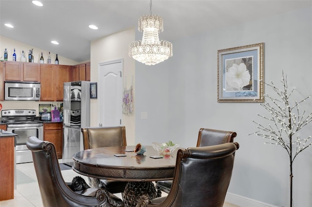 dining area with an inviting chandelier and lofted ceiling