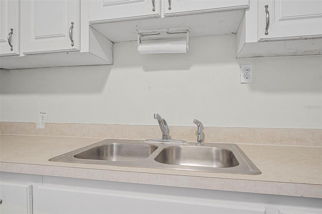 kitchen with white cabinetry and sink