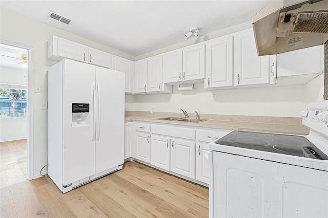 kitchen featuring white cabinetry, white appliances, and range hood