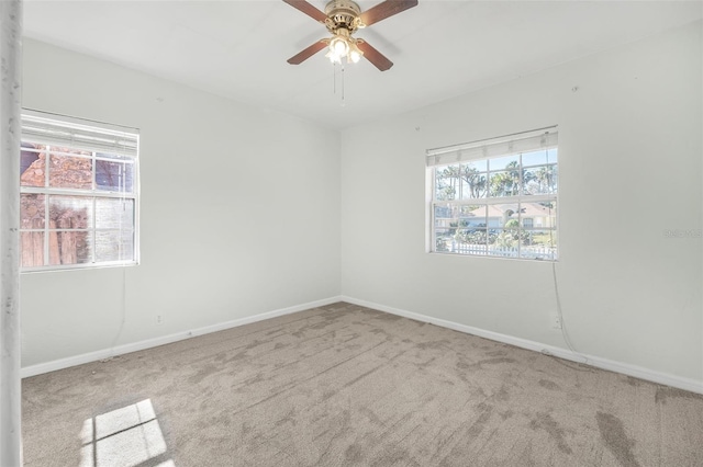 unfurnished room with ceiling fan and light carpet