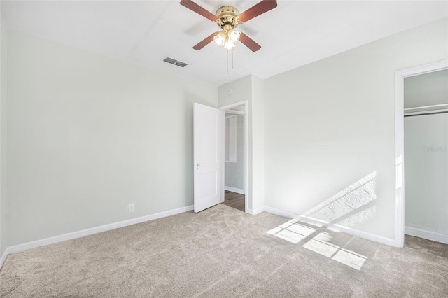 unfurnished bedroom with ceiling fan, light colored carpet, and a closet