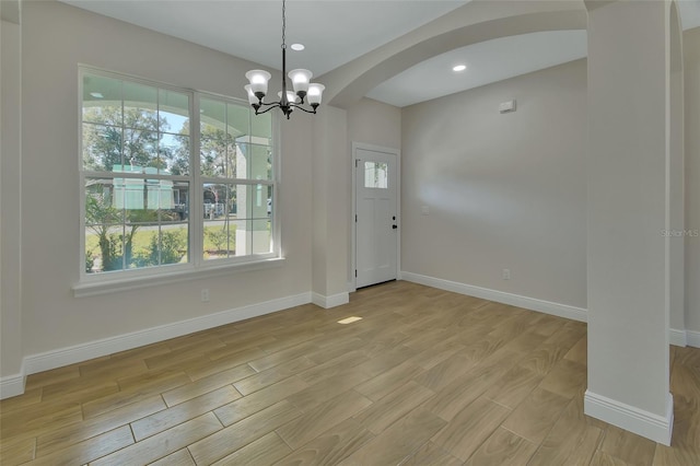 foyer featuring an inviting chandelier and light wood-type flooring