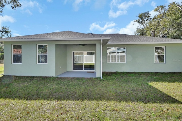 back of house with ceiling fan, a yard, and a patio area