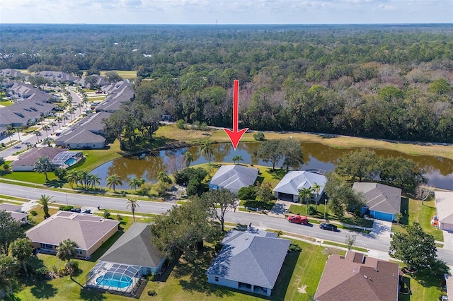 birds eye view of property with a residential view, a water view, and a forest view