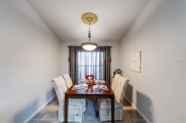 dining space with tile patterned flooring and baseboards