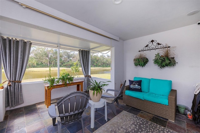 sitting room featuring stone tile flooring