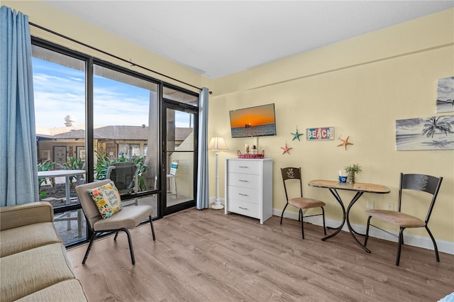 sitting room with wood finished floors and baseboards