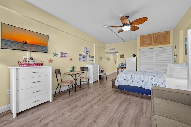 bedroom with baseboards, a ceiling fan, and light wood finished floors