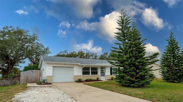 ranch-style house with a garage and a front lawn