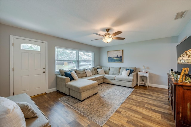 living room featuring dark hardwood / wood-style floors and ceiling fan