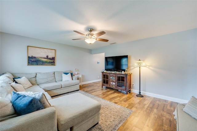 living room with hardwood / wood-style flooring and ceiling fan