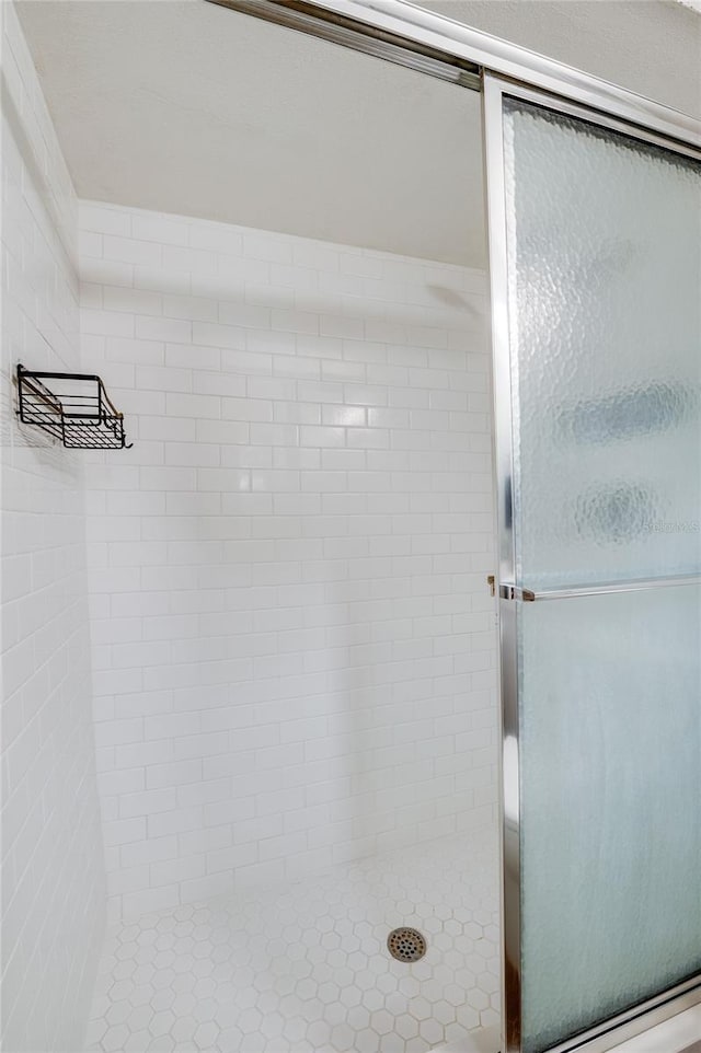 bathroom with a shower with door