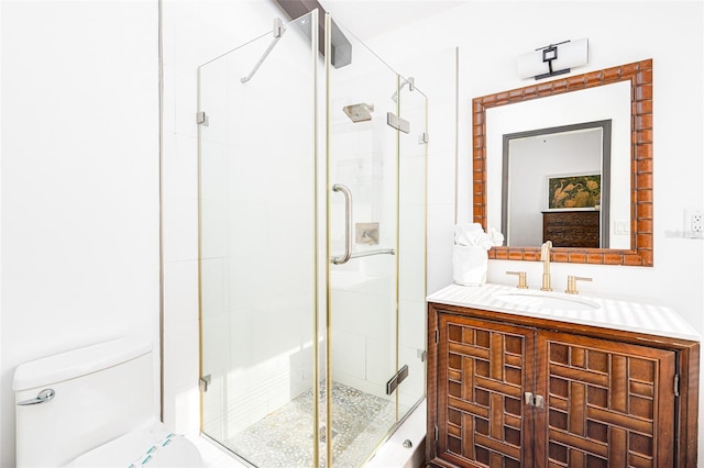 bathroom with walk in shower, vanity, and toilet