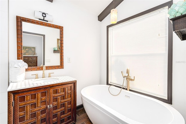 bathroom featuring hardwood / wood-style flooring, a bathing tub, and vanity