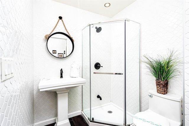 bathroom featuring toilet, an enclosed shower, and hardwood / wood-style floors