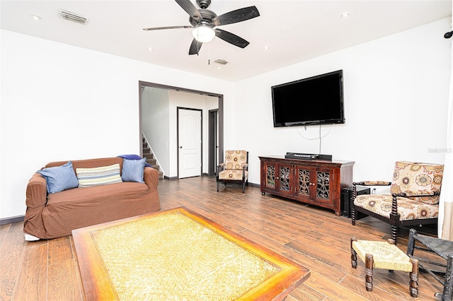 living room featuring hardwood / wood-style floors and ceiling fan