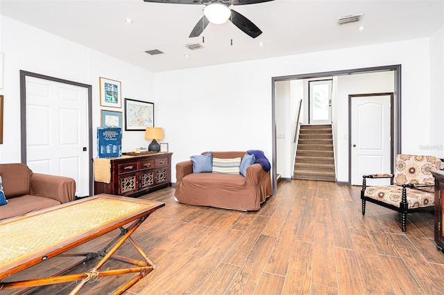 living room with ceiling fan and wood-type flooring