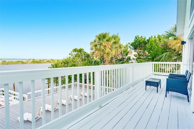 wooden terrace featuring a water view