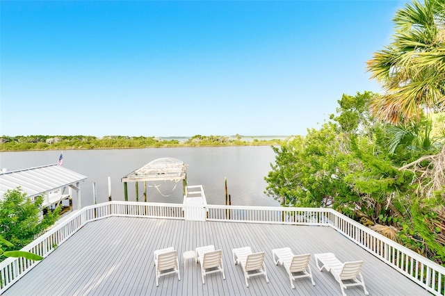 deck with a gazebo and a water view