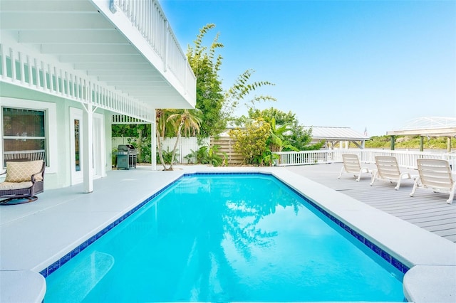 view of pool featuring a grill