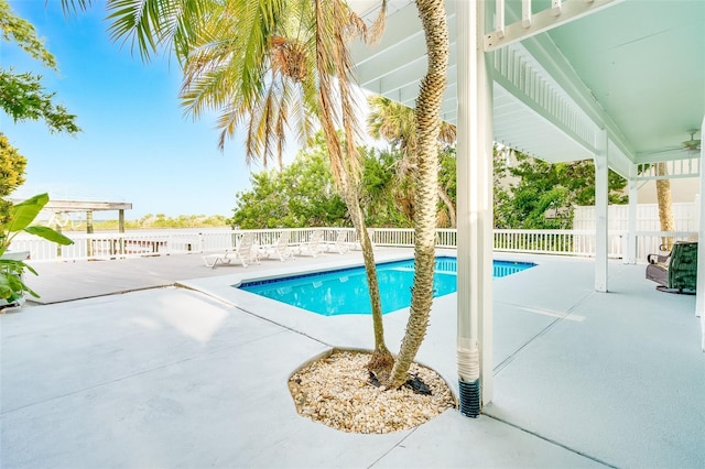 view of swimming pool with a patio and ceiling fan