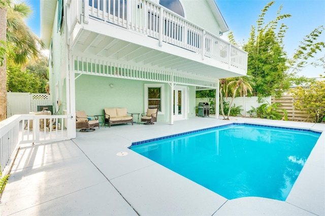 view of pool with grilling area and a patio area