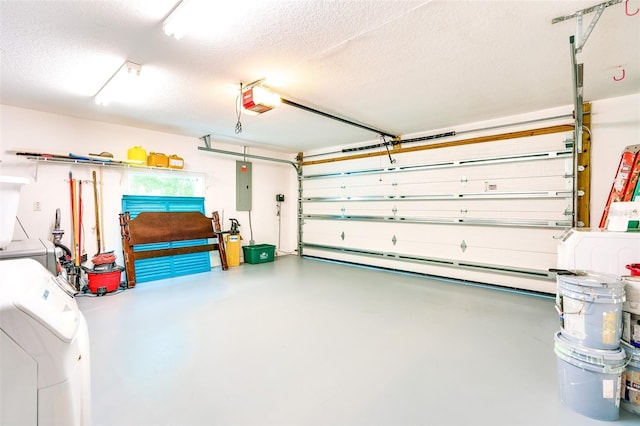 garage with washing machine and clothes dryer, a garage door opener, and electric panel