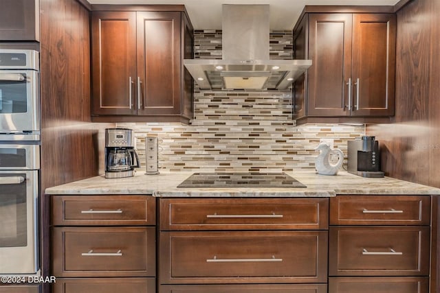 kitchen featuring black electric cooktop, light stone countertops, ventilation hood, and decorative backsplash