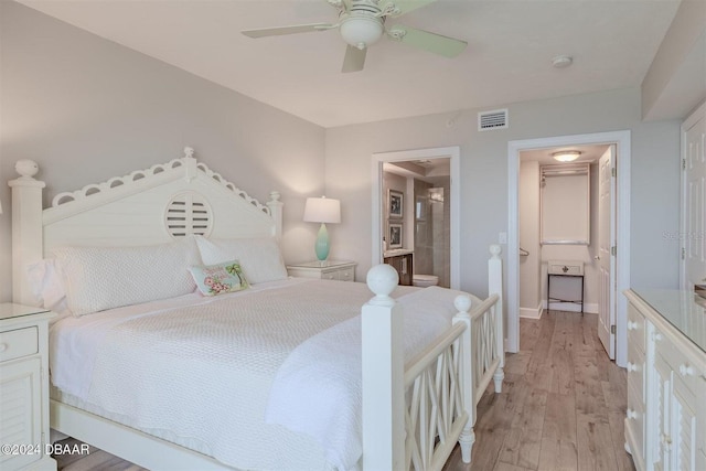 bedroom with connected bathroom, ceiling fan, and light hardwood / wood-style flooring