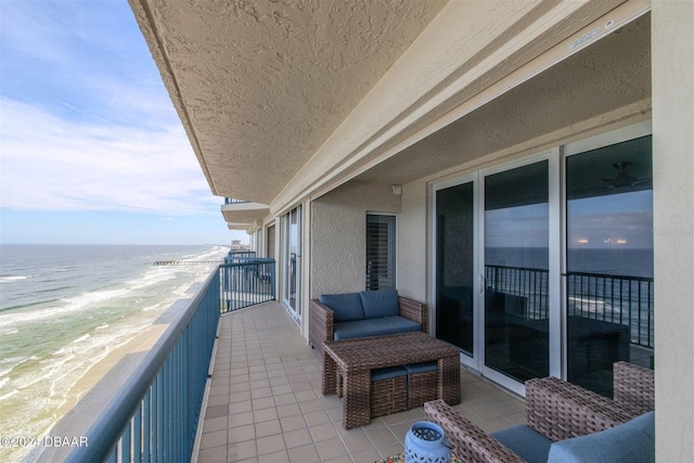 balcony with a beach view and a water view